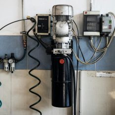Close-up of machinery and electrical components in a repair workshop.