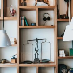 Elegant home interior featuring a wooden bookshelf with various decorative items and books.